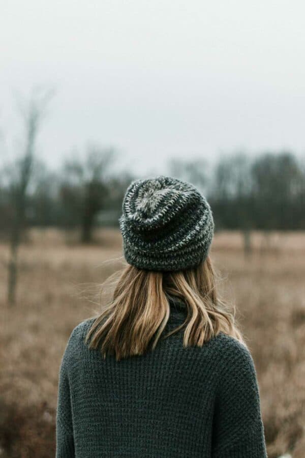 woman in black knit cap and gray knit sweater