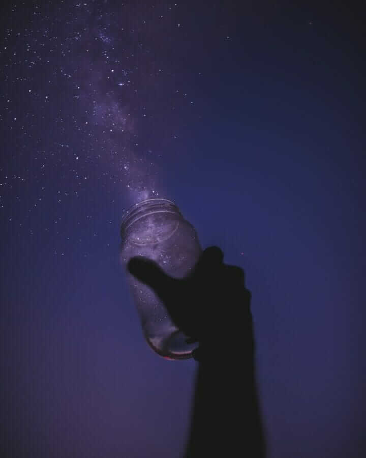 person holding glass jar