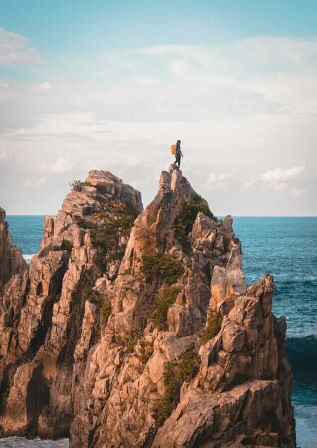 man standing on cliff