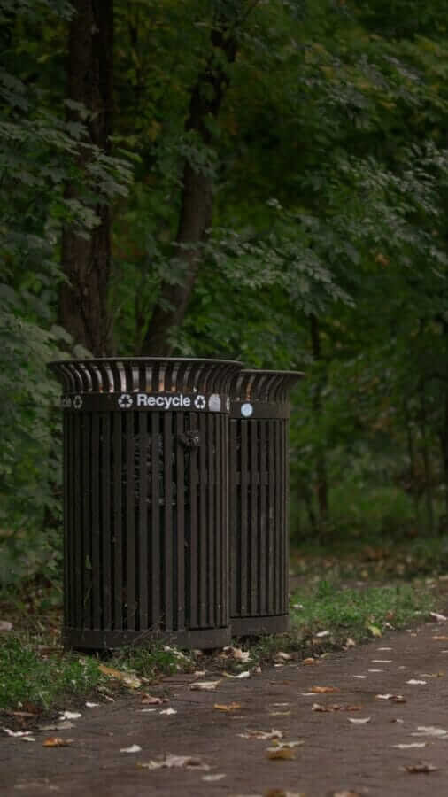 black wooden trash bin on green grass field