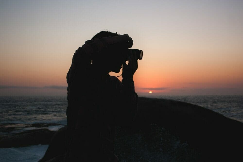 silhouette of person taking photograph