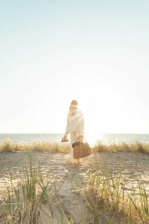 a woman standing on top of a sandy beach