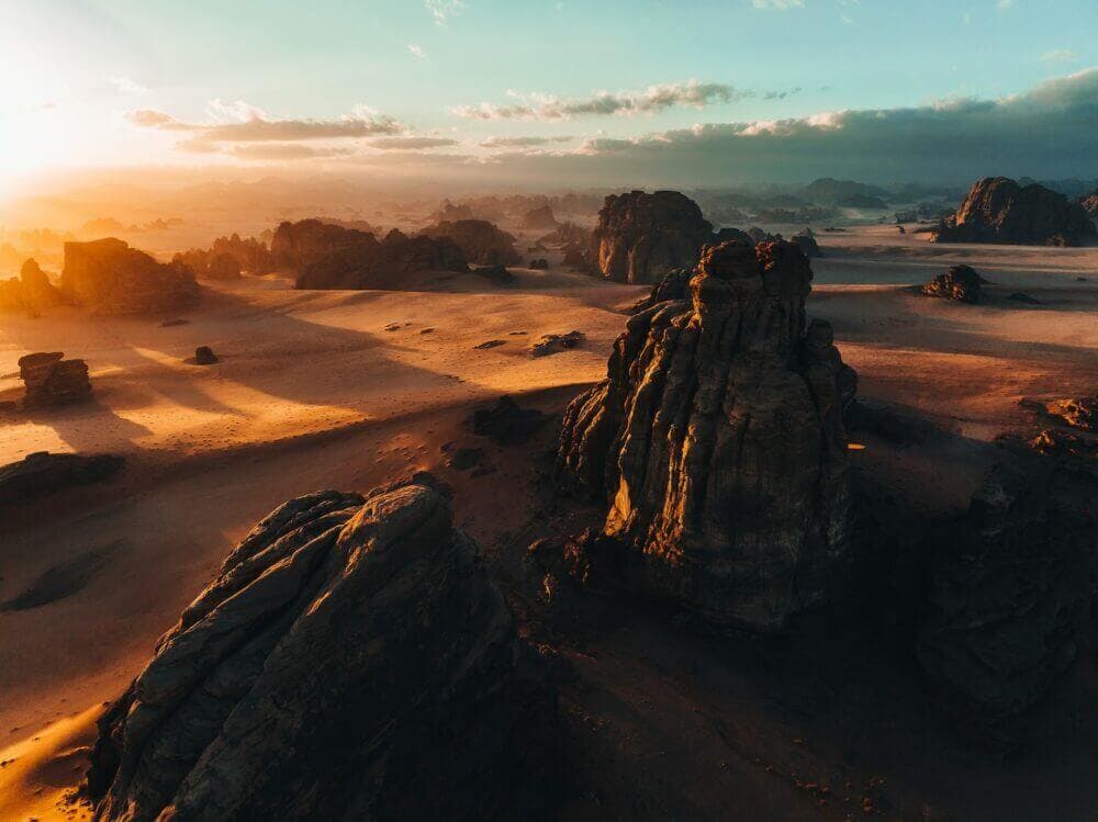 an aerial view of a desert at sunset