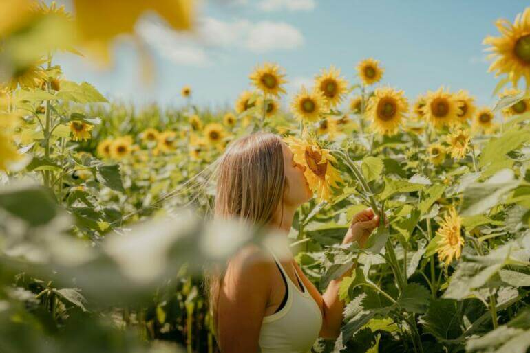 a woman standing in a field of sunflowers