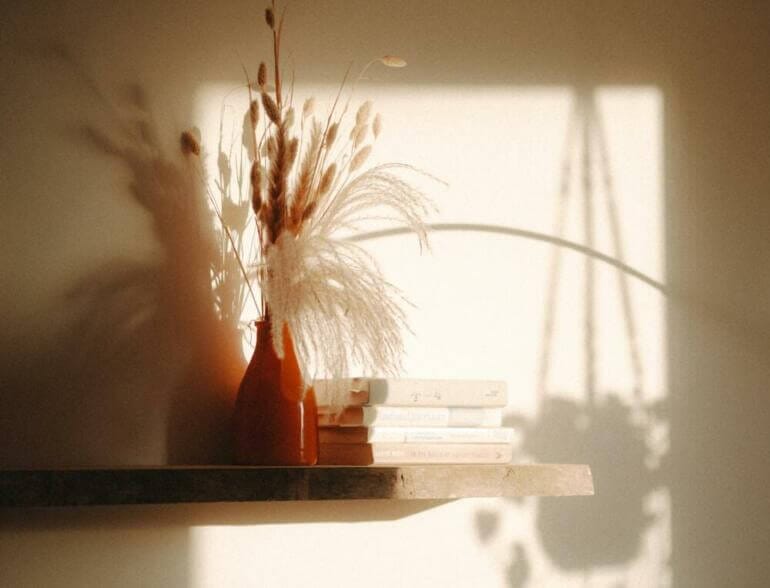 a couple of vases sitting on top of a shelf