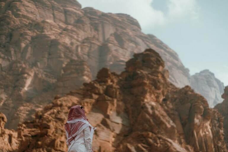 a person standing in front of a mountain