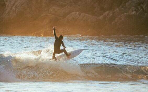 a man riding a wave on top of a surfboard