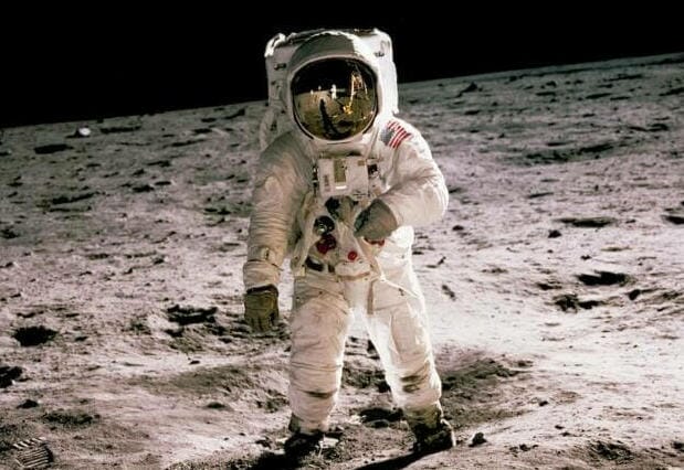 astronaut standing on gray sand