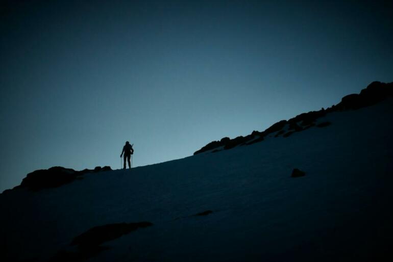 a person standing on top of a snow covered slope