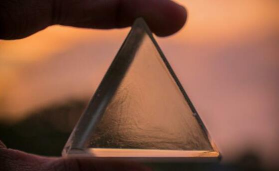 person holding triangle glass panel