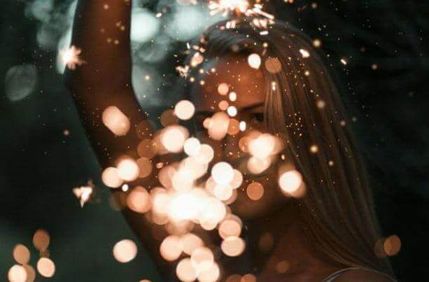woman holding sparklers bokeh photography