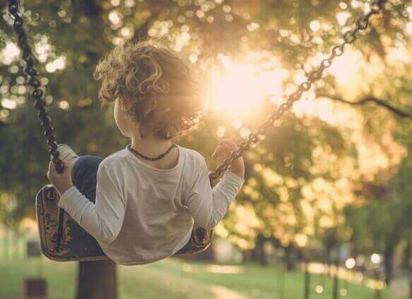 boy sitting on the swing