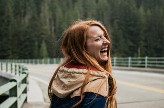 smiling woman leaning on right on road