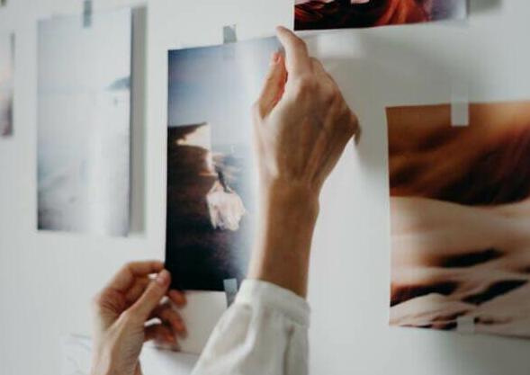 Photo of Person Putting Photo on Wall