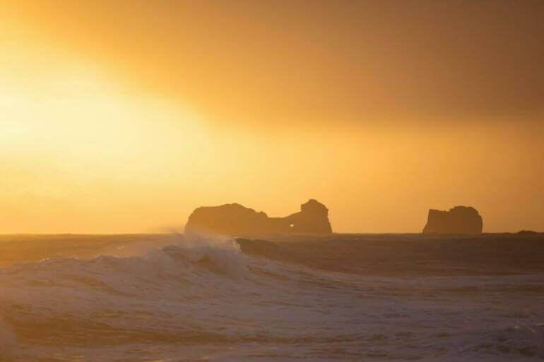 A person riding a surfboard on a wave in the ocean