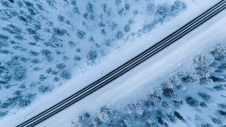 An aerial view of a road in the snow